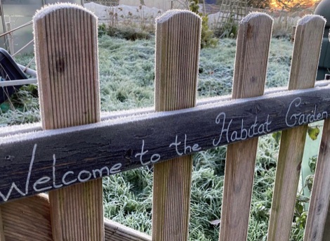 Habitat Garden painted on wooden gate